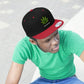A young man looks cool with the red and black Free The Plant Snapback Hat with green a cannabis leaf a green underbill and a matching green t-shirt