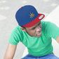 Picture of a young man curiously looking on in a green t shirt with the red and blue Gold Marijuana Leaf Snapback Hat