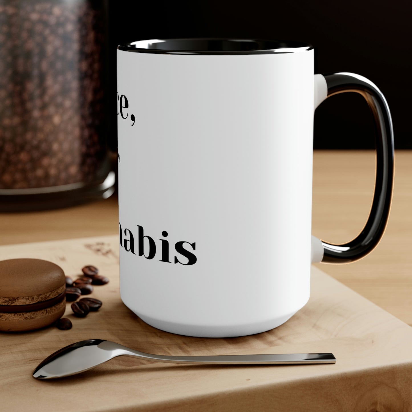 a Peace, Love and Cannabis Mug with a spoon and coffee beans on it.