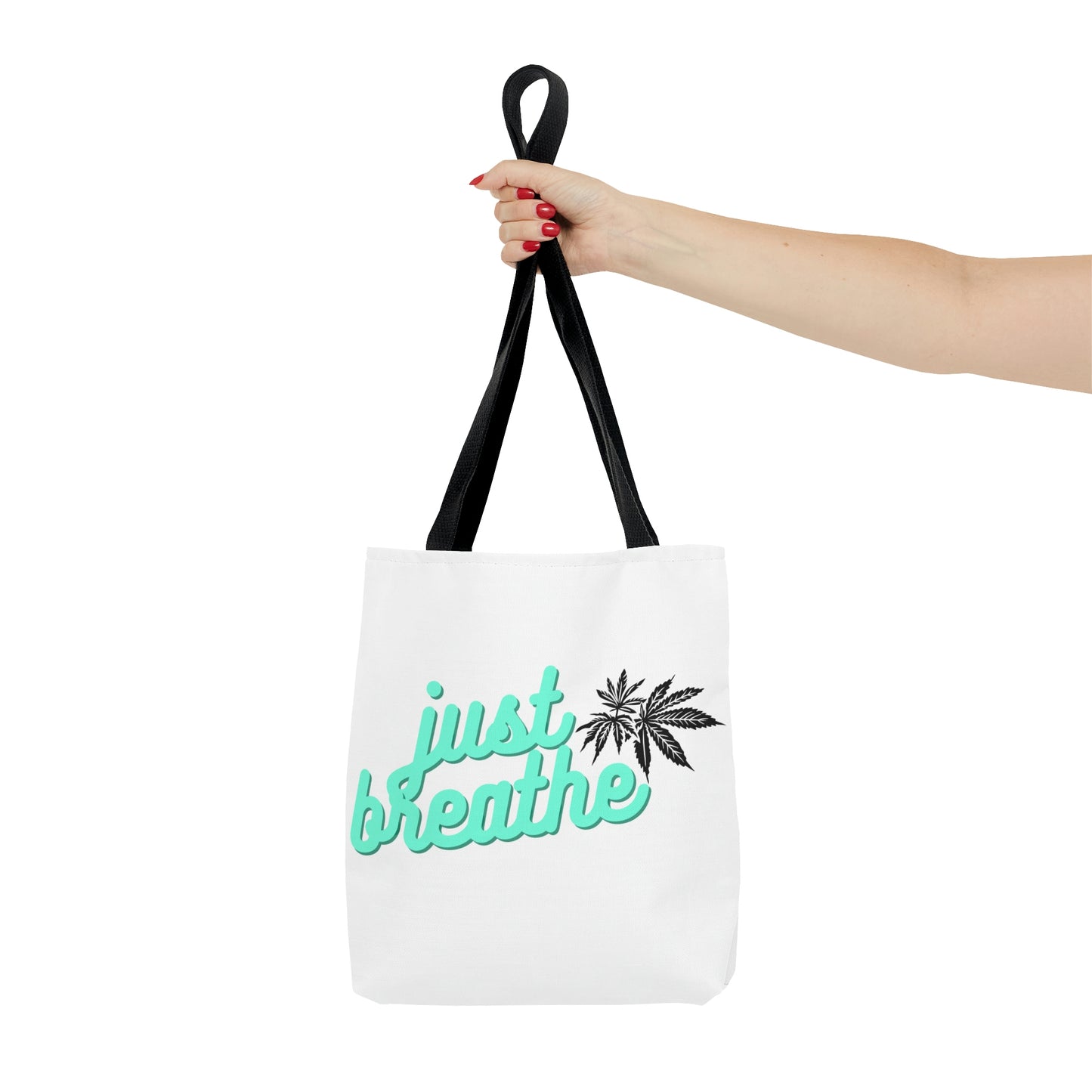 A woman with red nails holds out the Just Breathe Cannabis Tote Bag