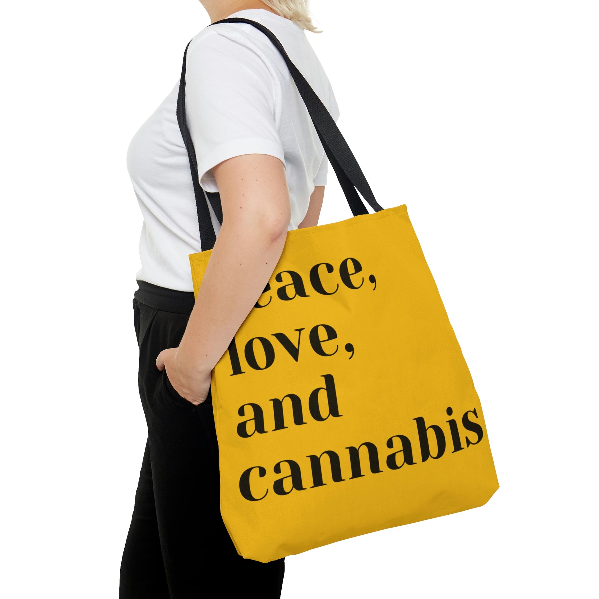 A woman in black pants matches stylishly with a Peace, Love and Cannabis Yellow Tote Bag 