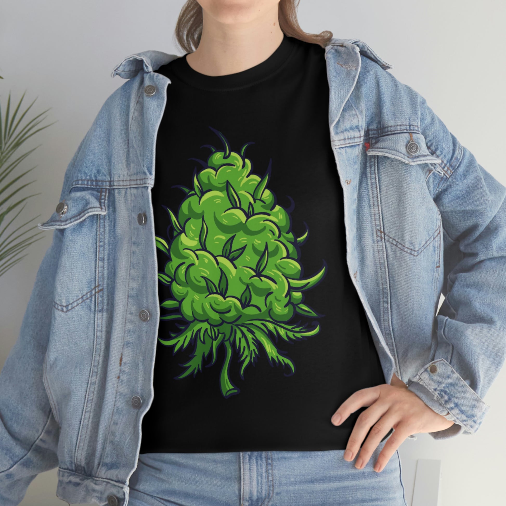 a woman wearing a black Big Cannabis Bud Heavy Cotton Tee with a green marijuana plant on it.