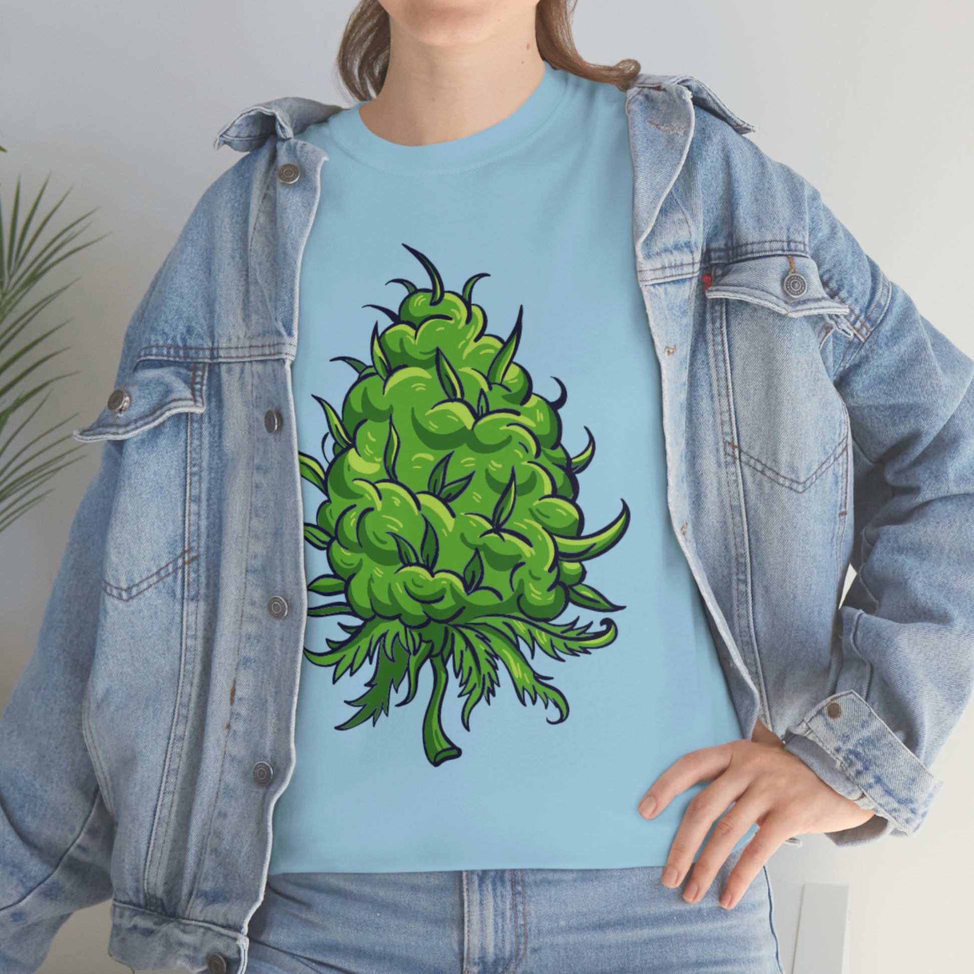 a woman wearing a Big Cannabis Bud Heavy Cotton Tee with a green marijuana plant on it.