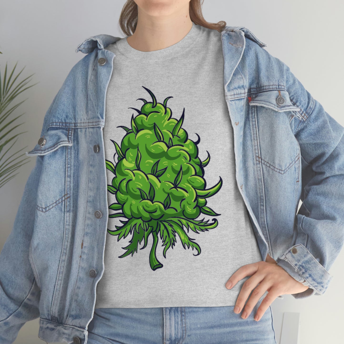 a woman wearing a Big Cannabis Bud Heavy Cotton Tee with a green marijuana plant on it.