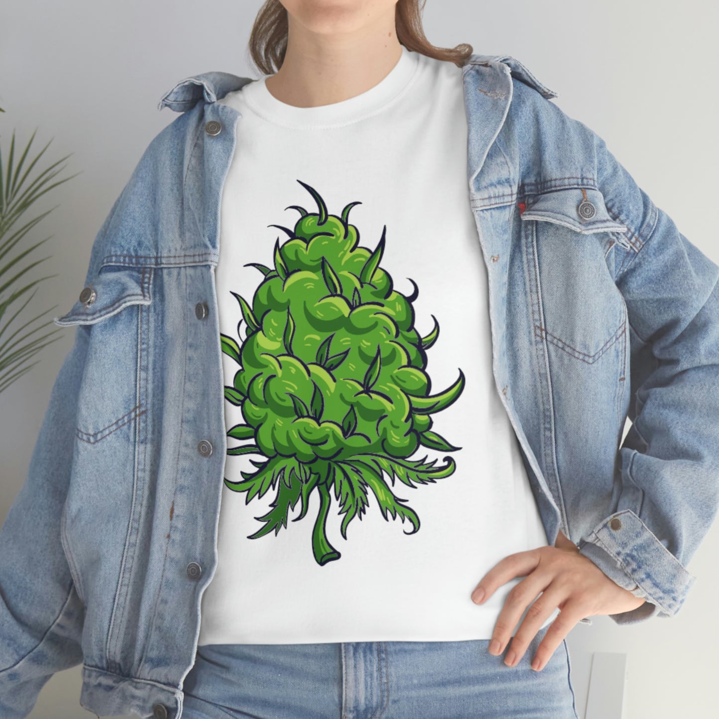 A woman wearing a Big Cannabis Bud Heavy Cotton Tee with a green marijuana plant on it.