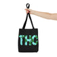 A perfect presentation of a person outstretched holding the nicely designed THC Black Weed-Themed Tote Bag
