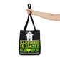 A woman is holding her arm outstretched to show how cool the Happiness Is Homegrown Black Marijuana Tote Bag looks