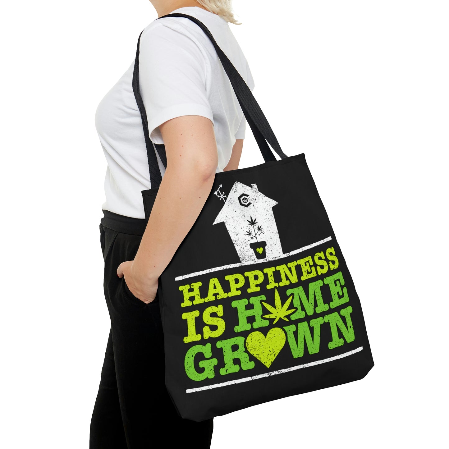 A woman is carrying the Happiness Is Homegrown Black Weed Tote Bag on her shoulder and it looks really nice