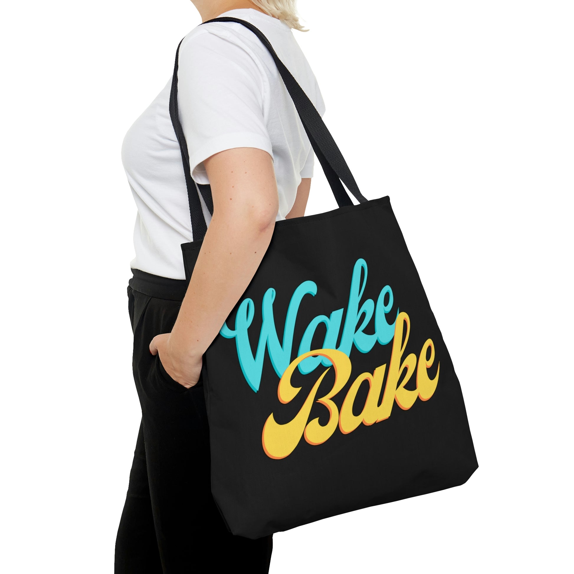 A woman is walking forward as she poses in the wake and bake Black Tote Bag