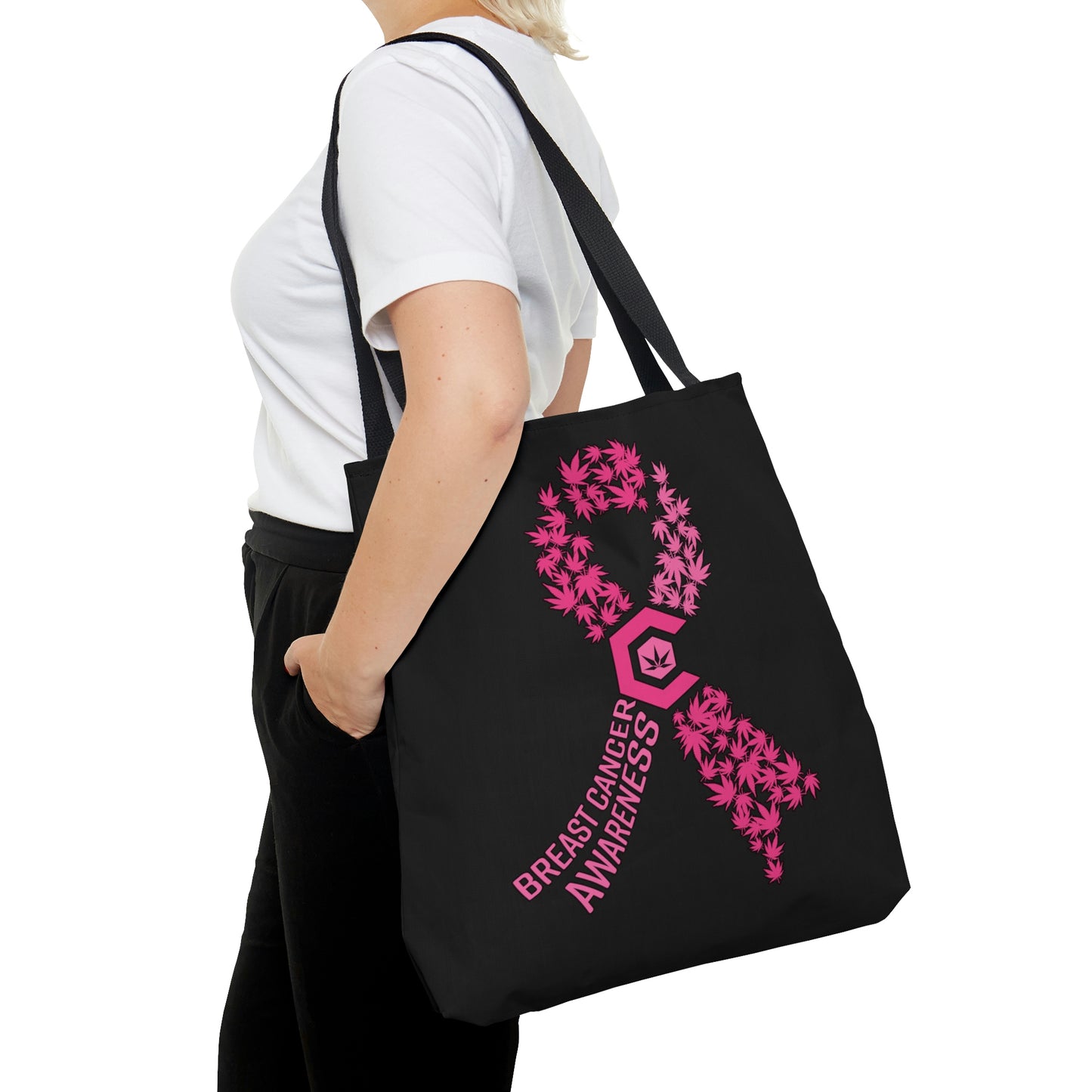 A woman with black pants wears the Breast Cancer Awareness Black Tote Bag with Pink weed leaves integrated into the awareness ribbon
