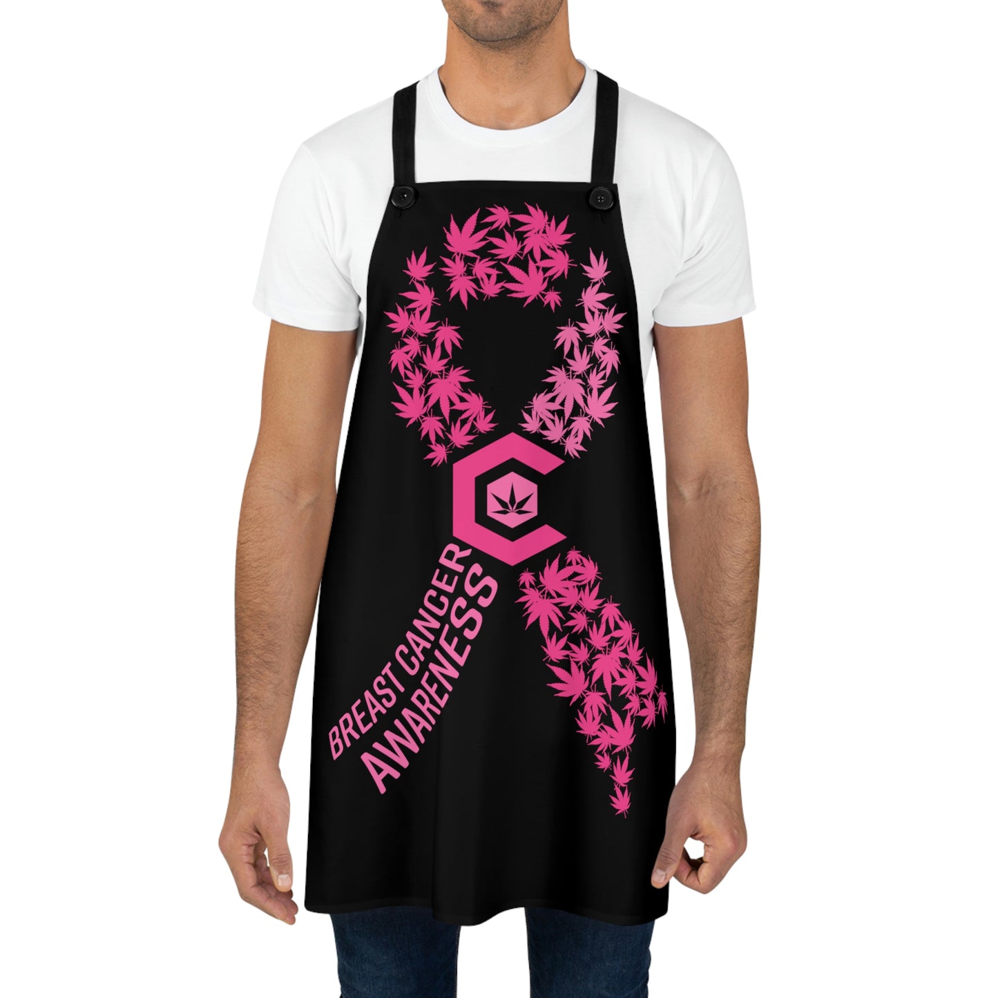 A man wearing the Breast Cancer Awareness Chef's Apron with a C in the middle surrounding the weed leaf with pink cannabis leaves