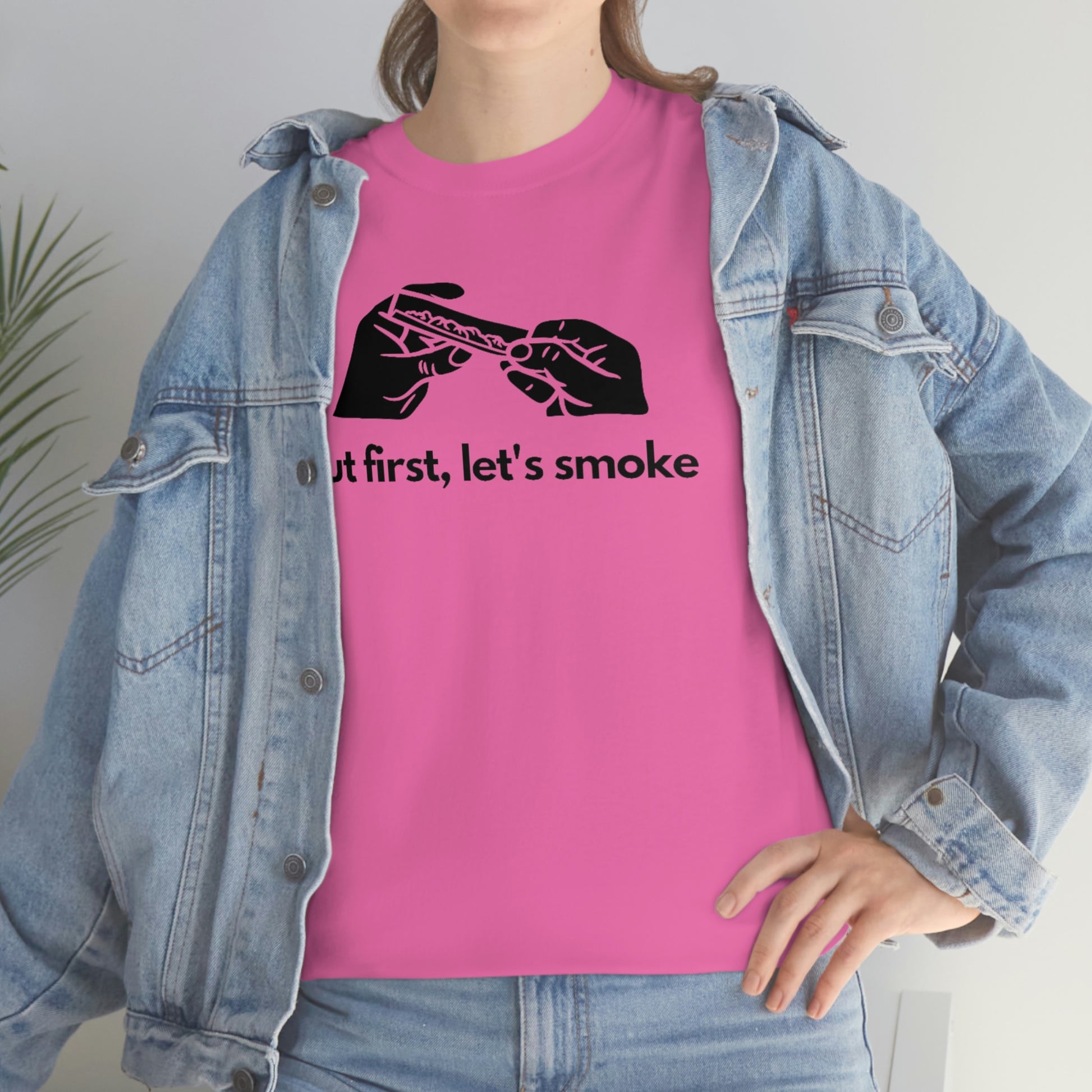 a woman wearing a pink But First, Let's Smoke Tee