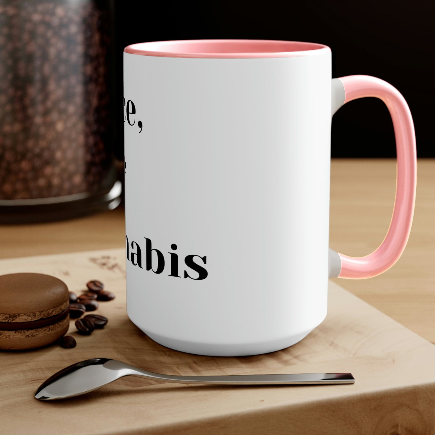 a Peace, Love and Cannabis Mug with a spoon and coffee beans on it.