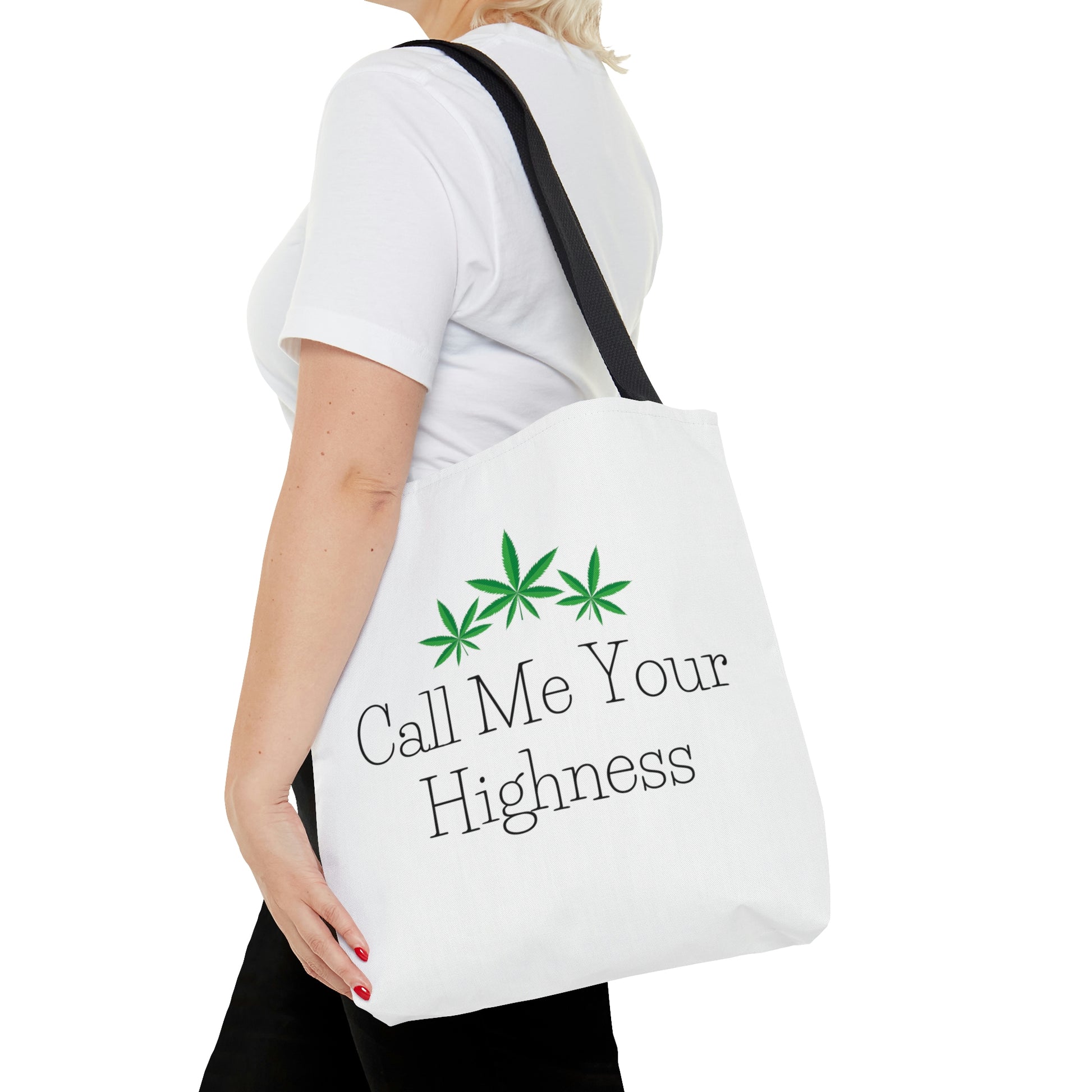 A woman in a white t shirt with black pants is carrying the Call Me Your Highness Green Leaf Tote Bag on her shoulder