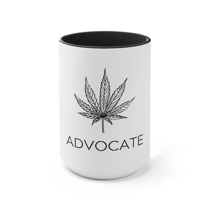 a black and white cannabis coffee mug with a marijuana leaf above the words "advocate"