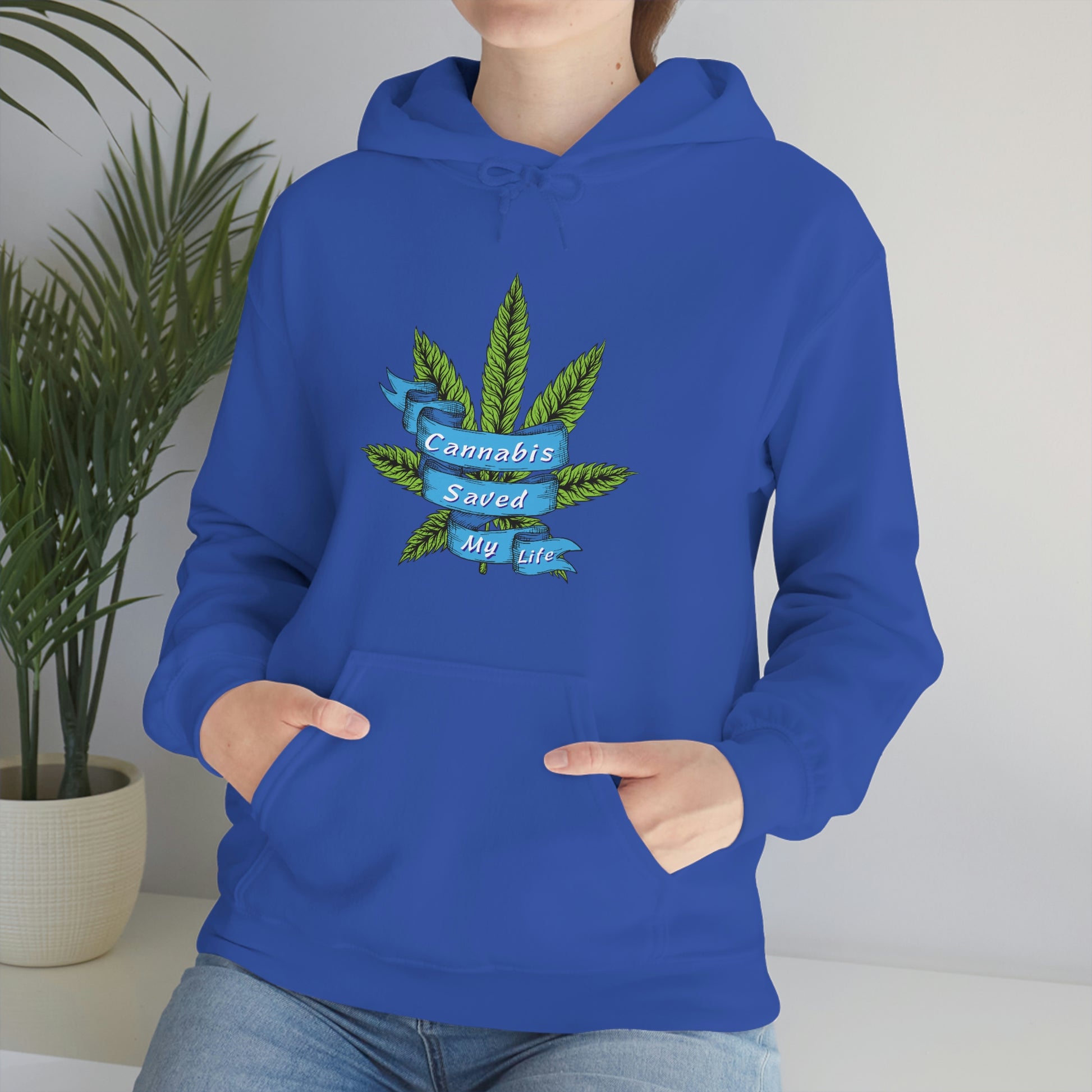 a woman wearing a blue Cannabis Saved My Life Cannabis Hoodie with a marijuana leaf on it.