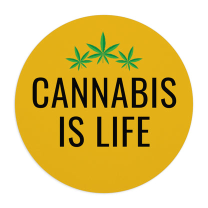 Round Cannabis is Life yellow mouse pad with the phrase "cannabis is life" in black text, flanked by three green cannabis leaves.