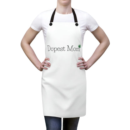 a woman wearing a white apron with the product name, Dopest Mom Pot Leaf Chef's Apron, on it.