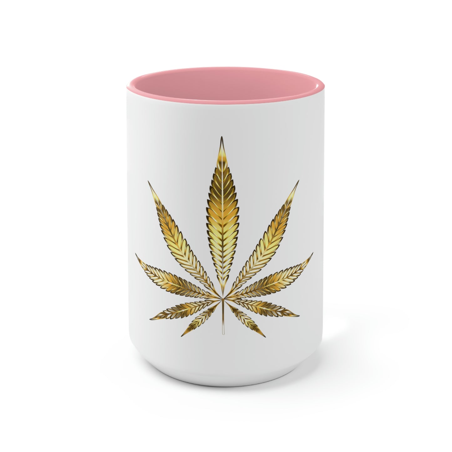 A white cannabis mug with a pink interior featuring a bright gold weed leaf on the front center.
