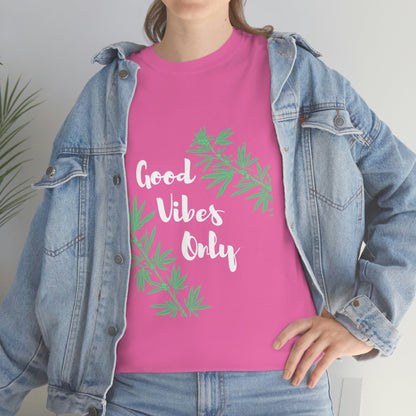 A person wearing the Good Vibes Only Leaf T-Shirt in pink, featuring cannabis leaf designs, peeks out from under a laid-back denim jacket.