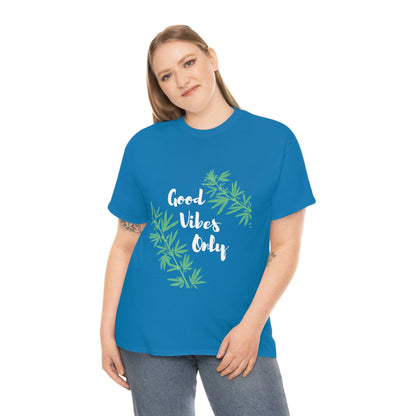 A person dressed in the "Good Vibes Only Leaf T-Shirt," featuring both a blue hue and vibrant cannabis leaf designs, stands against a plain white background.