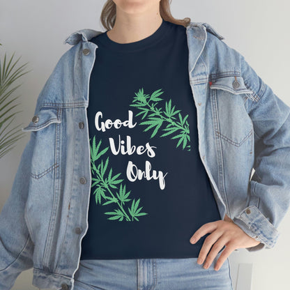 A person in a denim jacket wears the Good Vibes Only Leaf T-Shirt, featuring vibrant cannabis leaf designs.