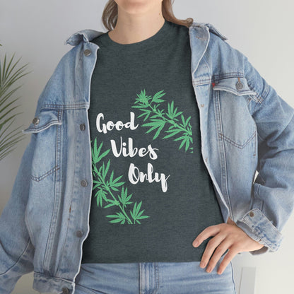 A person sports a denim jacket over the Good Vibes Only Leaf T-Shirt, elegantly adorned with intricate cannabis leaf designs.