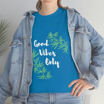 A person wearing the *Good Vibes Only Leaf T-Shirt*, which features cannabis leaf patterns, layered under a denim jacket.