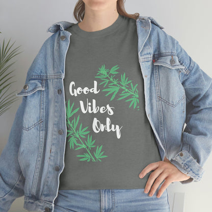 A person wearing a denim jacket paired with the Good Vibes Only Leaf T-Shirt, featuring a green base and cannabis leaf designs.