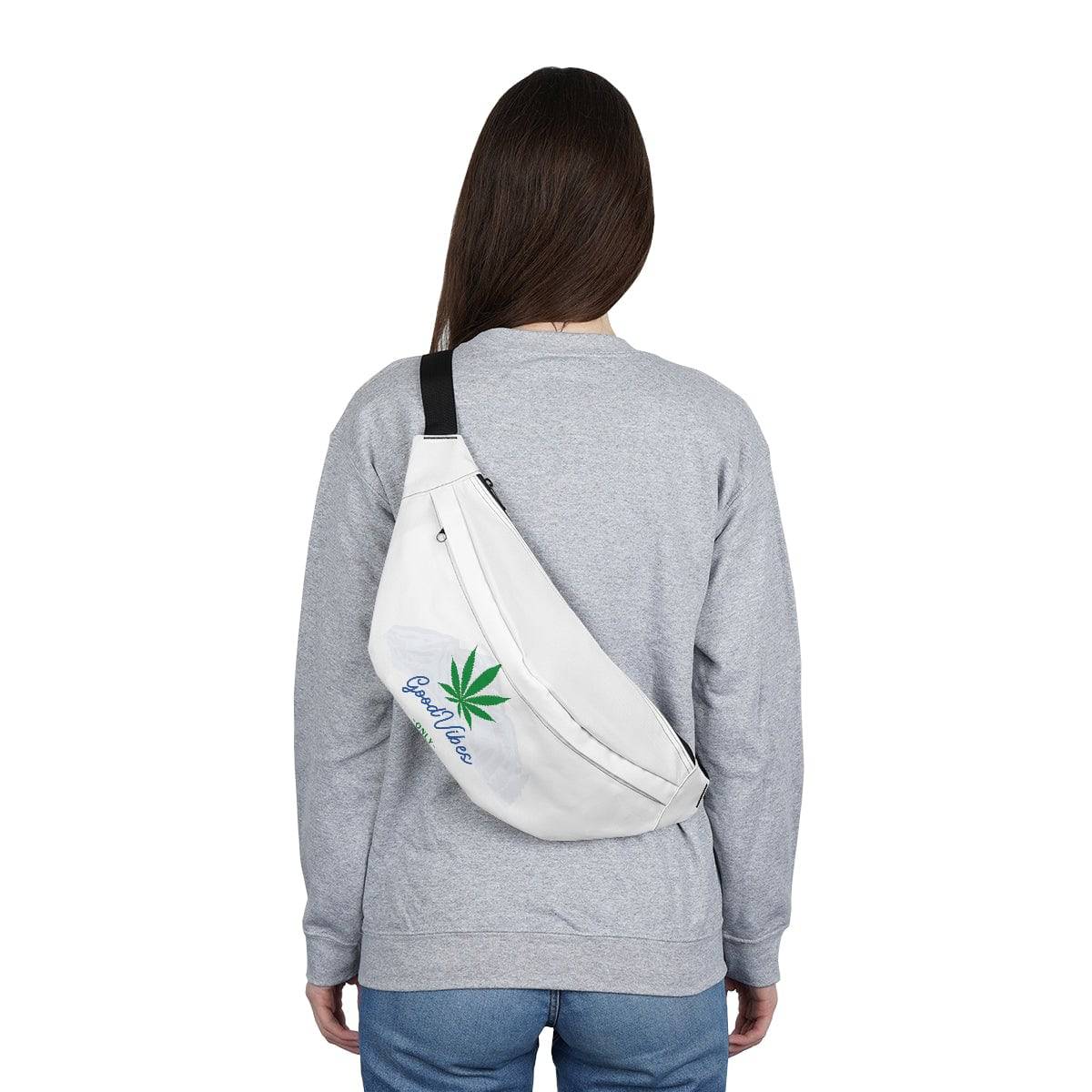 the back of a woman wearing a white fanny pack that has the words good vibes only surrounded by a mountain backdrop