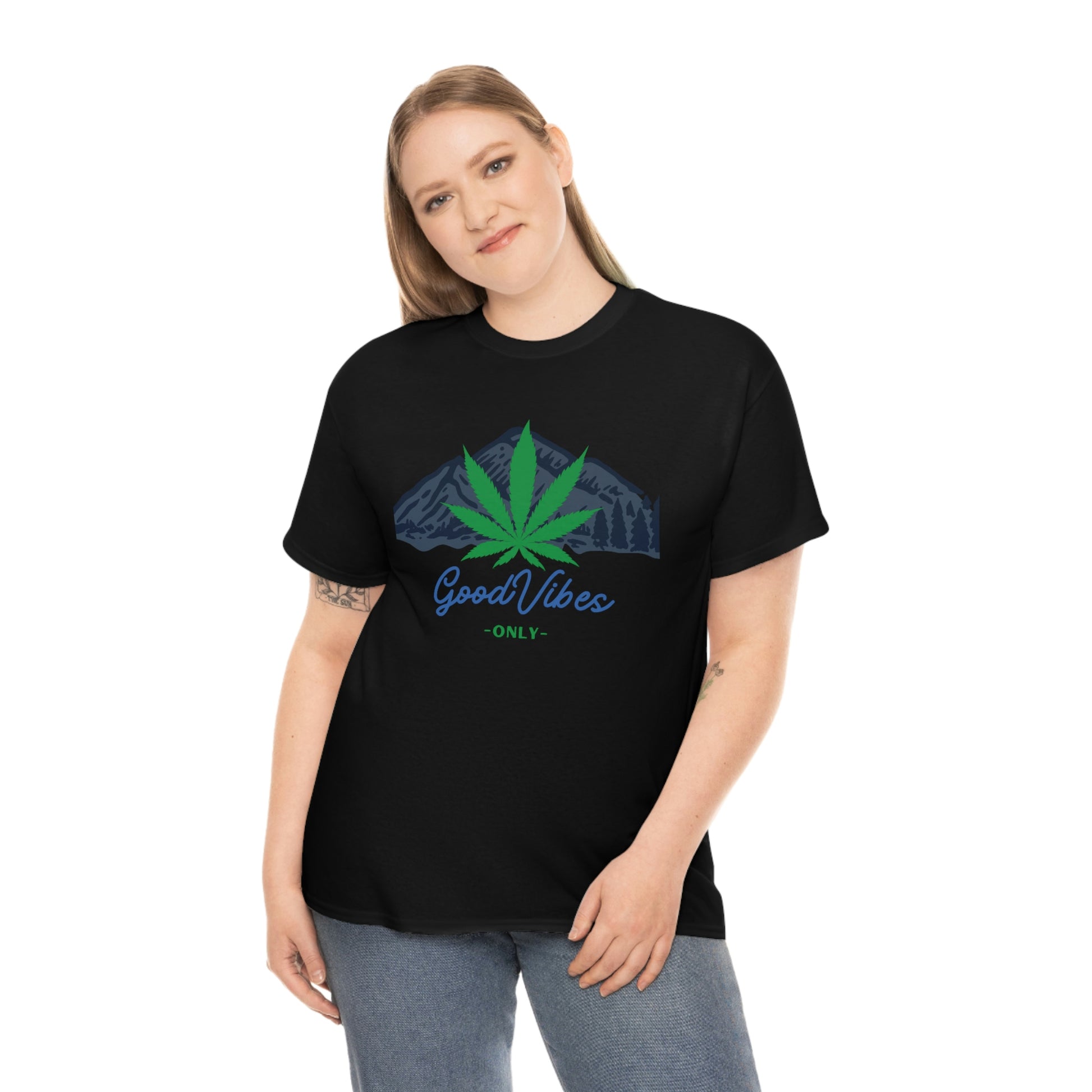 a woman wearing a black Good Vibes Only Mountain Tee with a marijuana leaf on it.