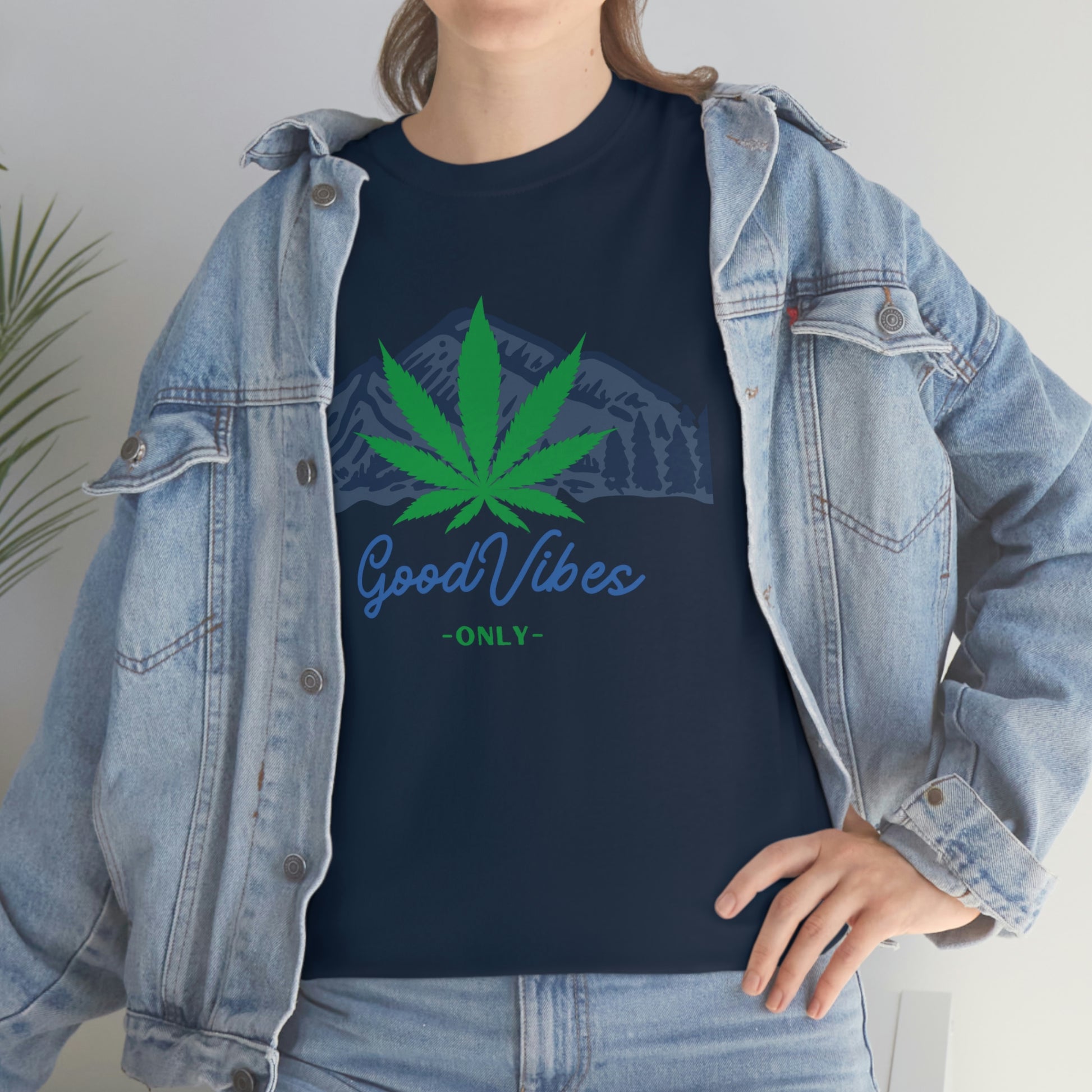 a woman wearing a denim jacket and a Good Vibes Only Mountain Tee.