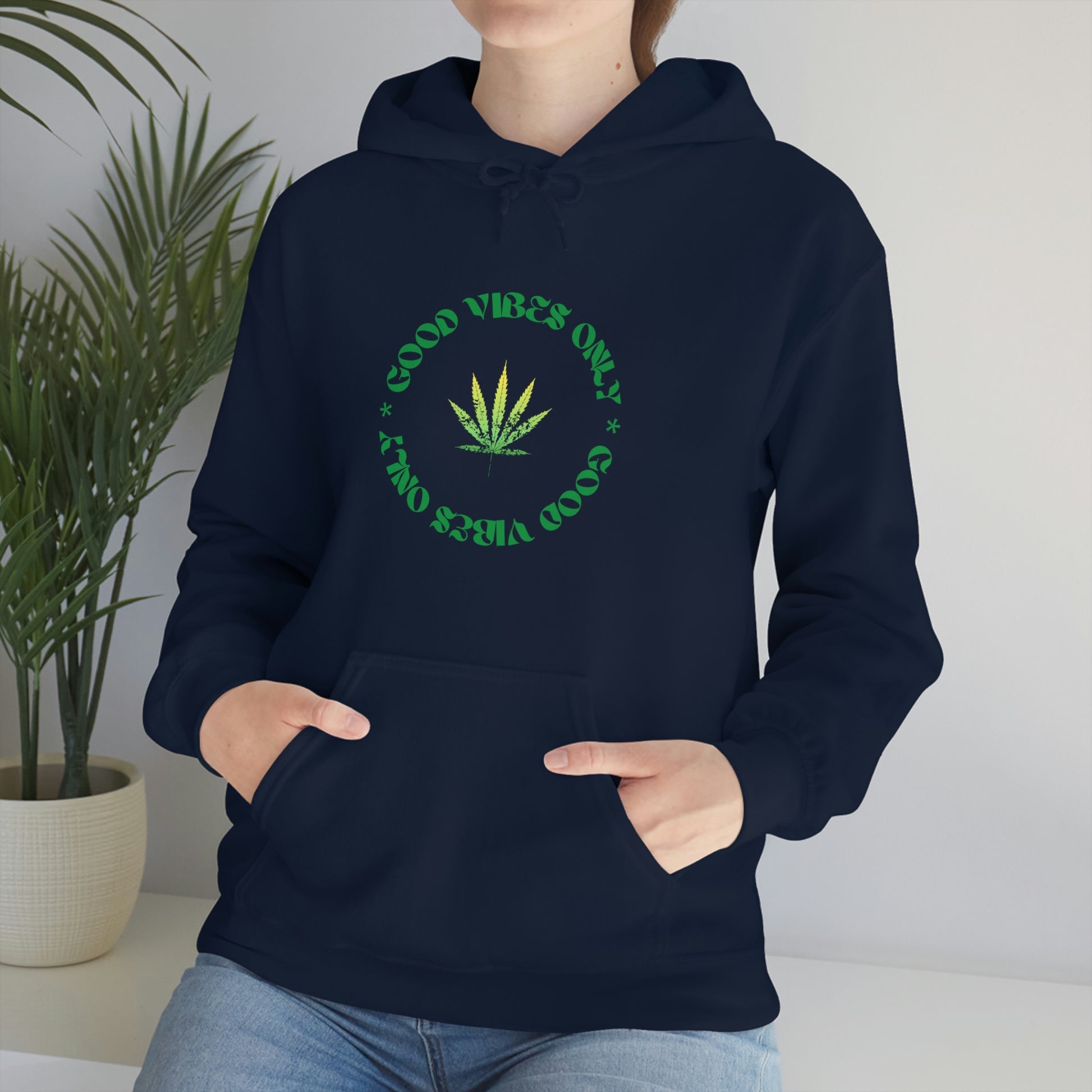 A woman wearing a Good Vibes Only Weed Sweater.