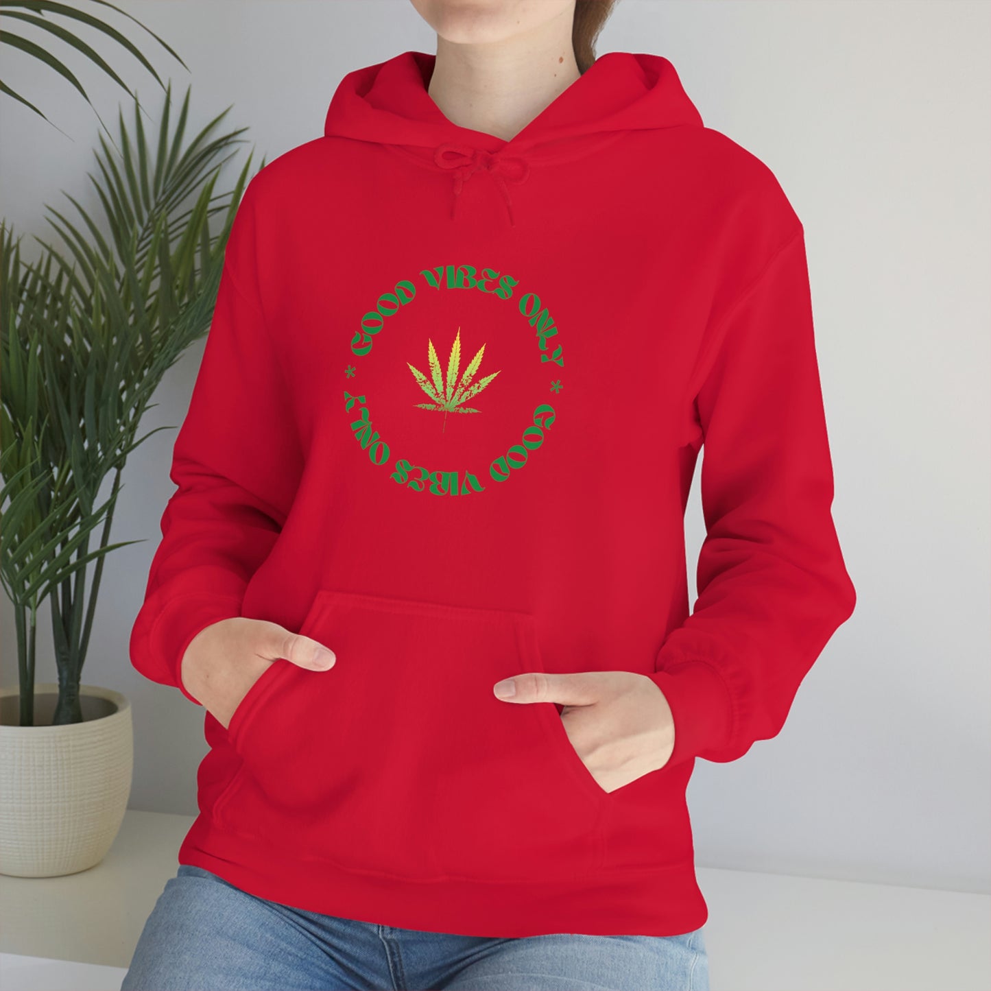 A woman wearing a red Good Vibes Only Weed Sweater.