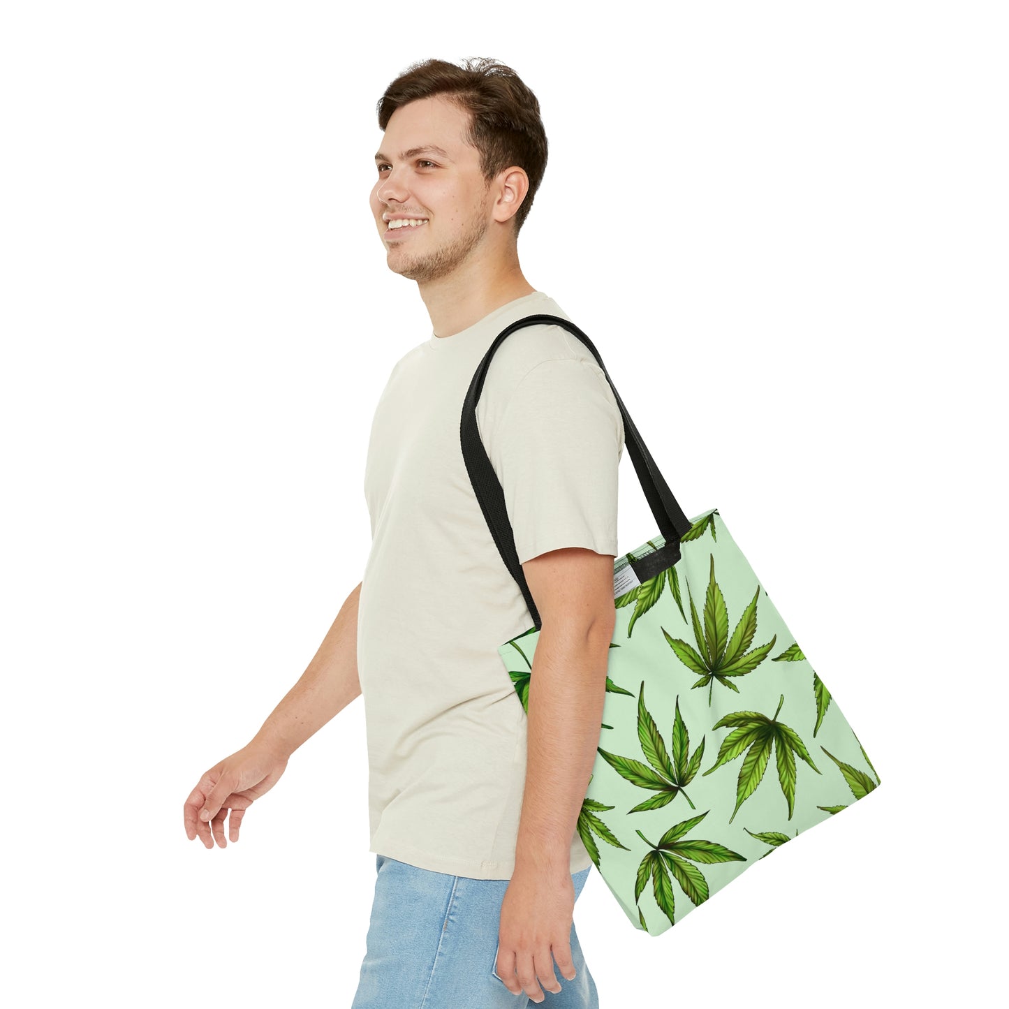 A man walks with a steady pace while he pleasantly wears the Marijuana Leaves Green Tote Bag
