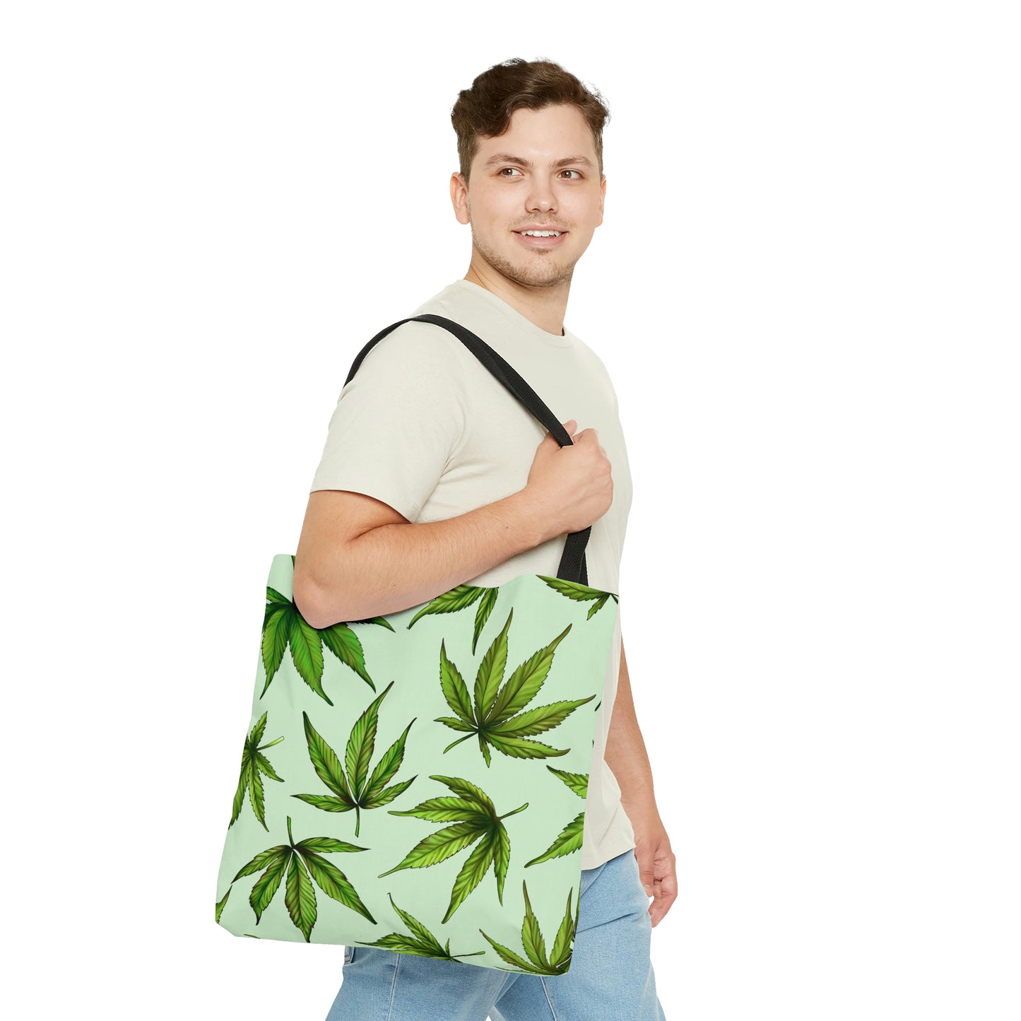 A man is happily staring while wearing the Marijuana Leaves Green Tote Bag 