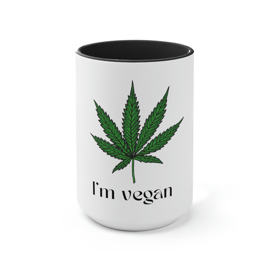 An I'm Vegan, black and white coffee mug with a green marijuana leaf on the front