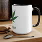 A black and white "I'm Vegan" cannabis coffee mug on a wooden table with a spoon and macaroon