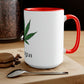 A white and red "I'm Vegan" cannabis coffee mug on a wooden table with a macaroon, coffee beans and a spoon