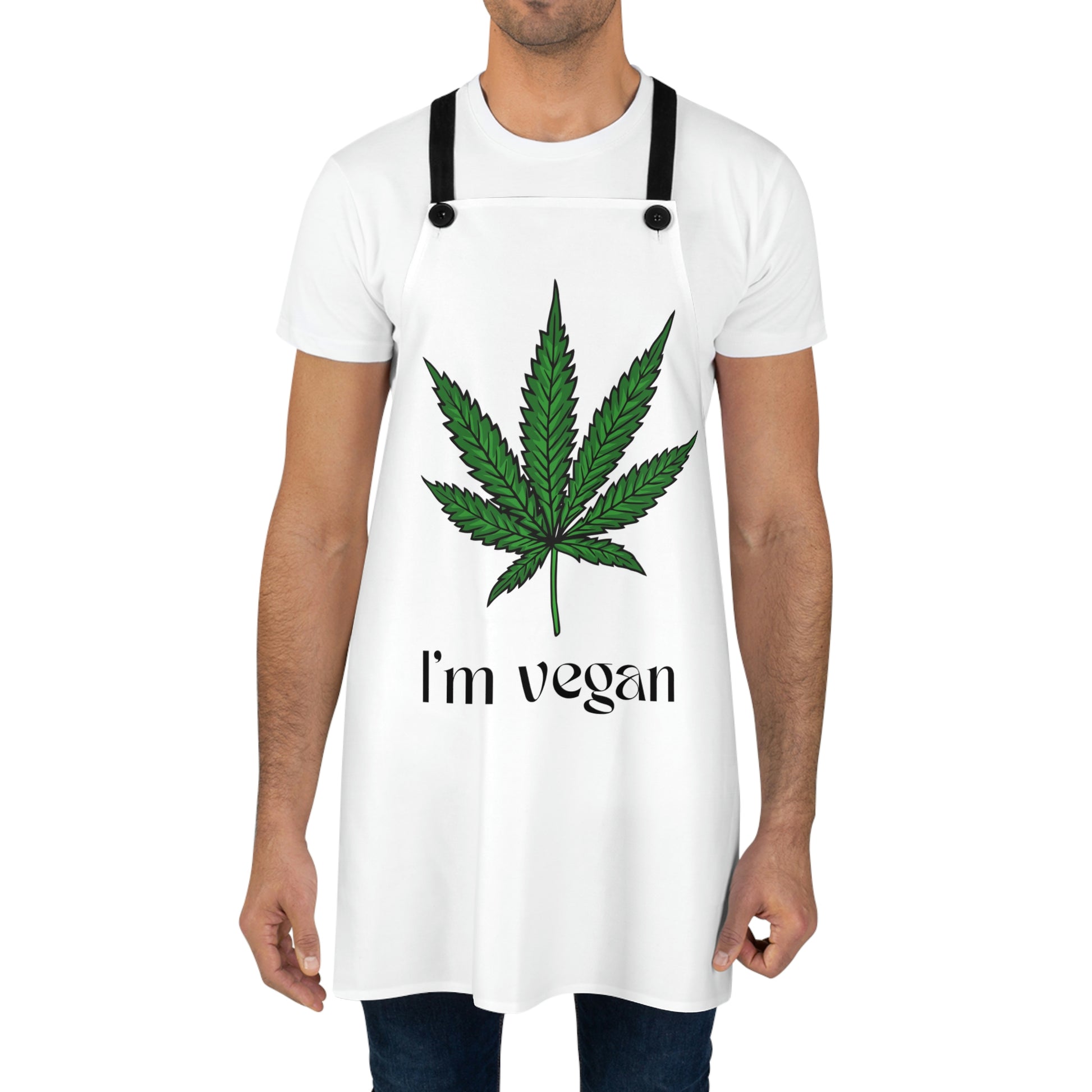 A man has on the white and green I'm Vegan Weed Leaf Chef's Apron with a green weed leaf in the center with I'm Vegan written underneath