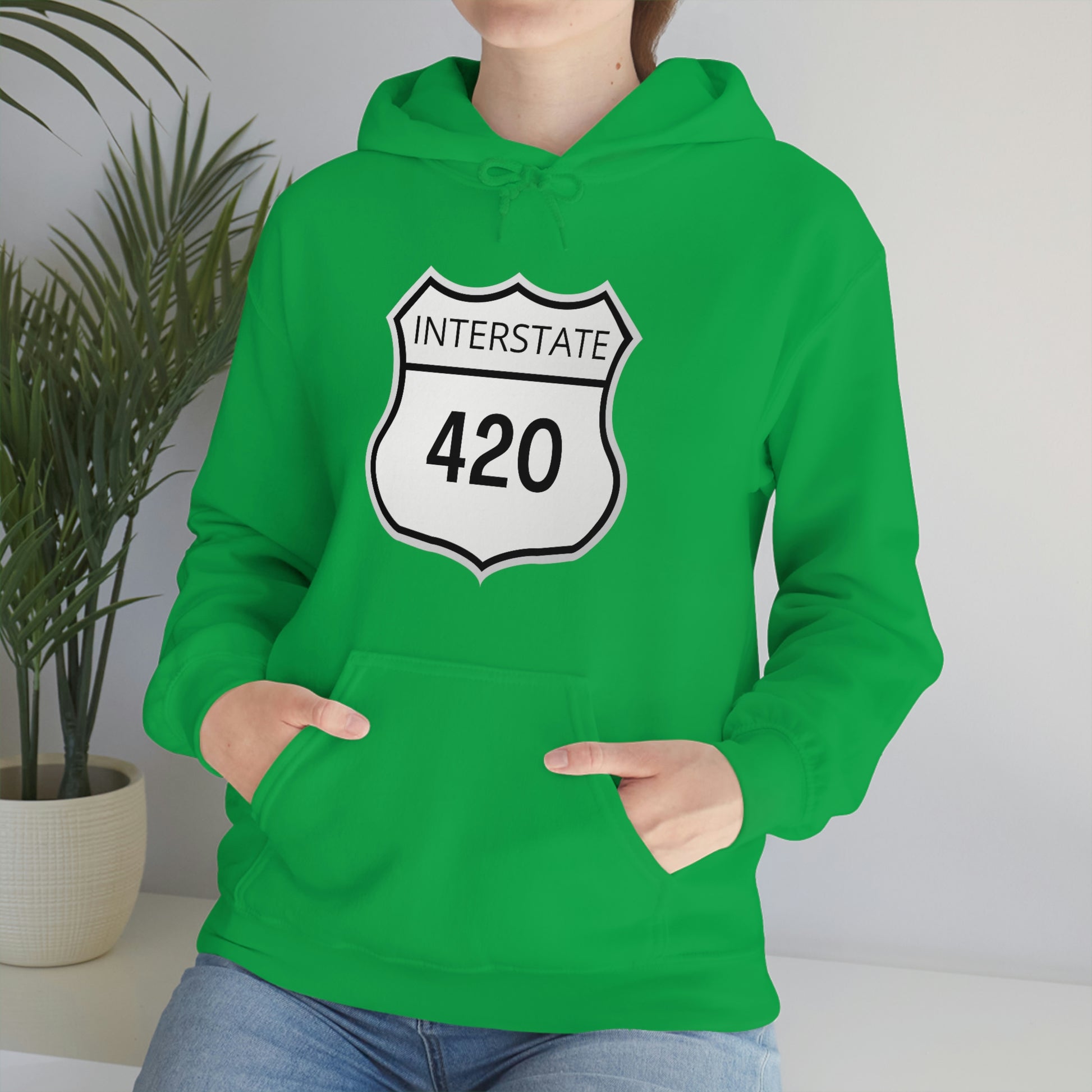 A woman wearing a green, interstate 420 marijuana hoodie