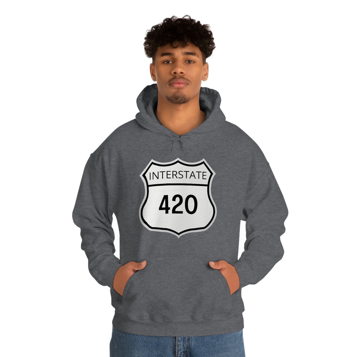 A young man wearing a charcoal gray Interstate 420 marijuana hoodie with his hands in his hoodie pocket