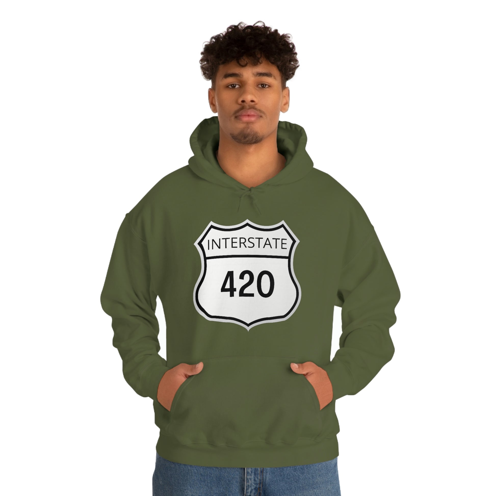 A young man wearing a forest green Interstate 420 marijuana hoodie with his hands in his hoodie pocket