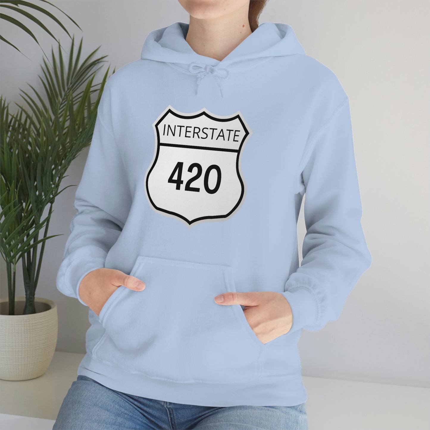 A woman wearing a light blue interstate 420 weed hoodie