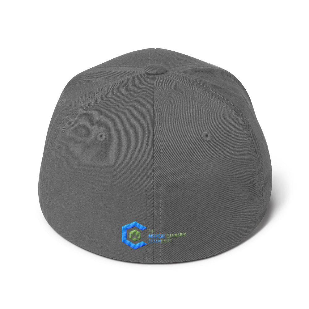 a grey snapback hat showing The Medical Cannabis Community logo and has The Medical Cannabis Community stitched next to the logo on back