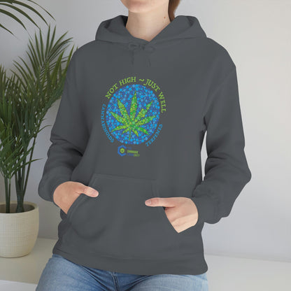 a woman wearing a gray Not High, Just Well Cannabis Hoodie with a marijuana leaf on it.