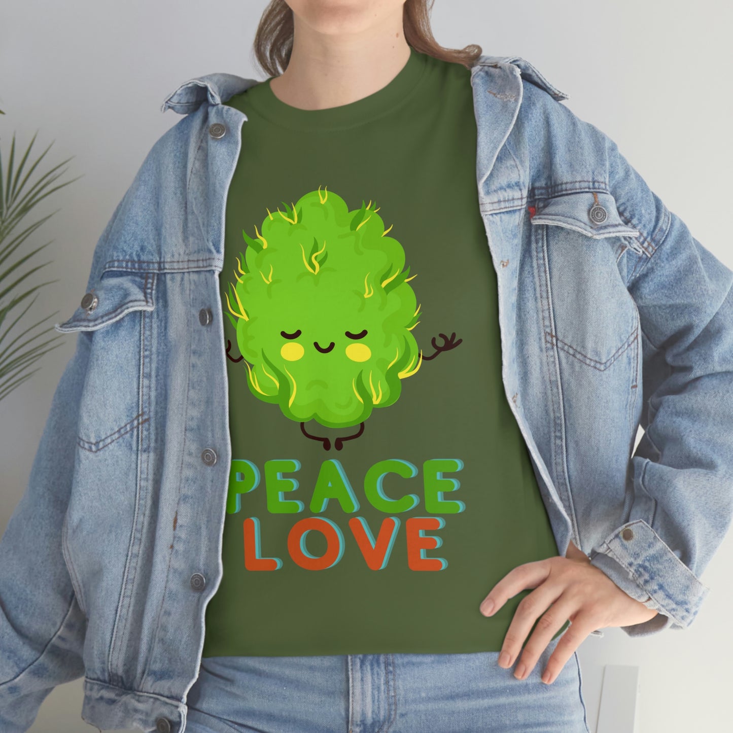 A woman wearing a Peace and Love Tee in green.