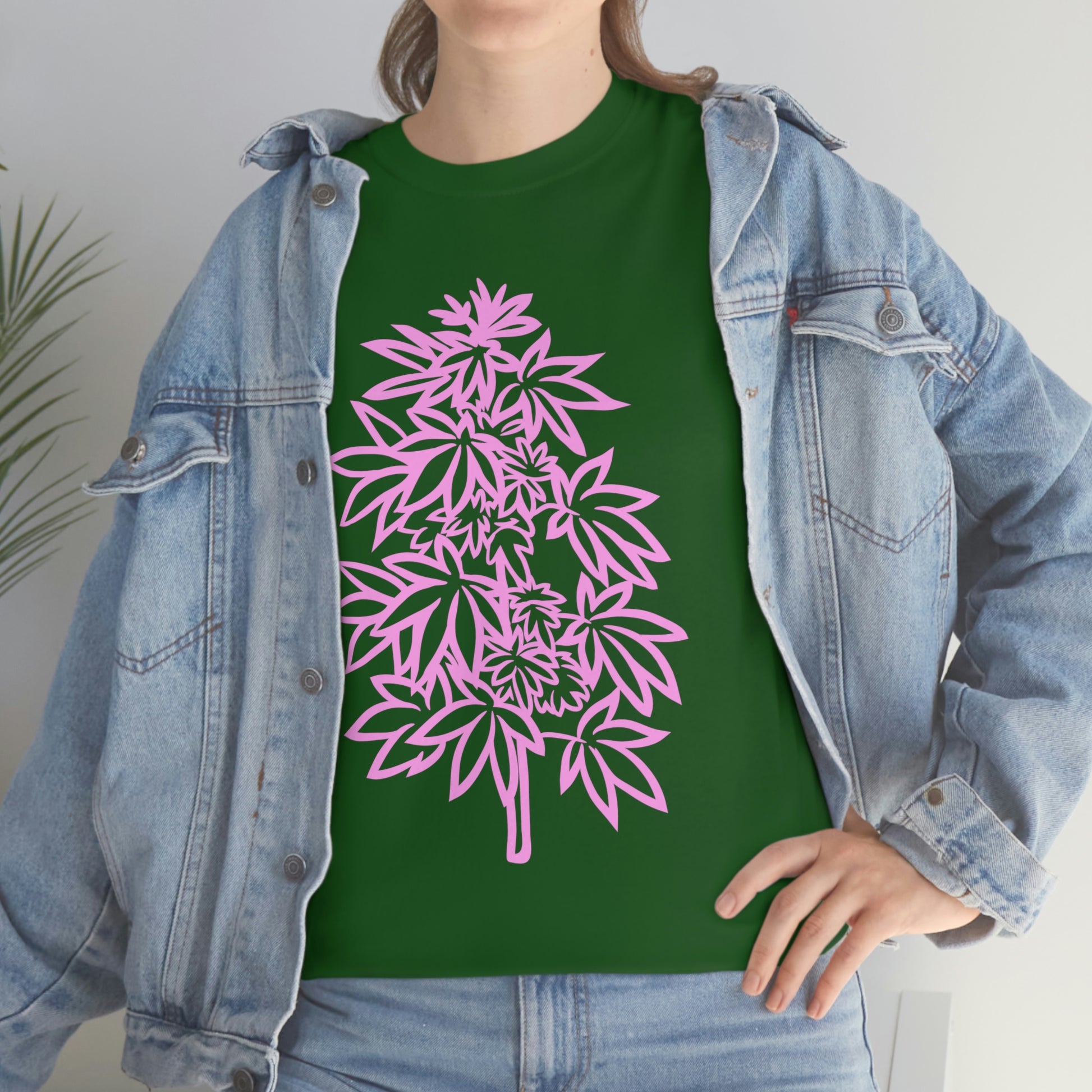 a woman wearing a Pink Cannabis Flowers Tee with pink marijuana leaves on it.
