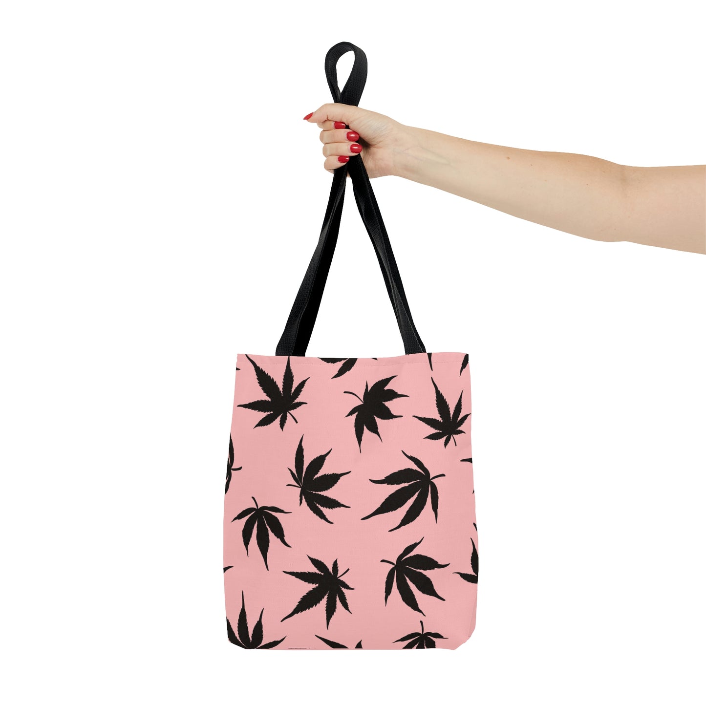 An outstretched hand shows how the Marijuana Leaves Pink Tote Bag stands alone  