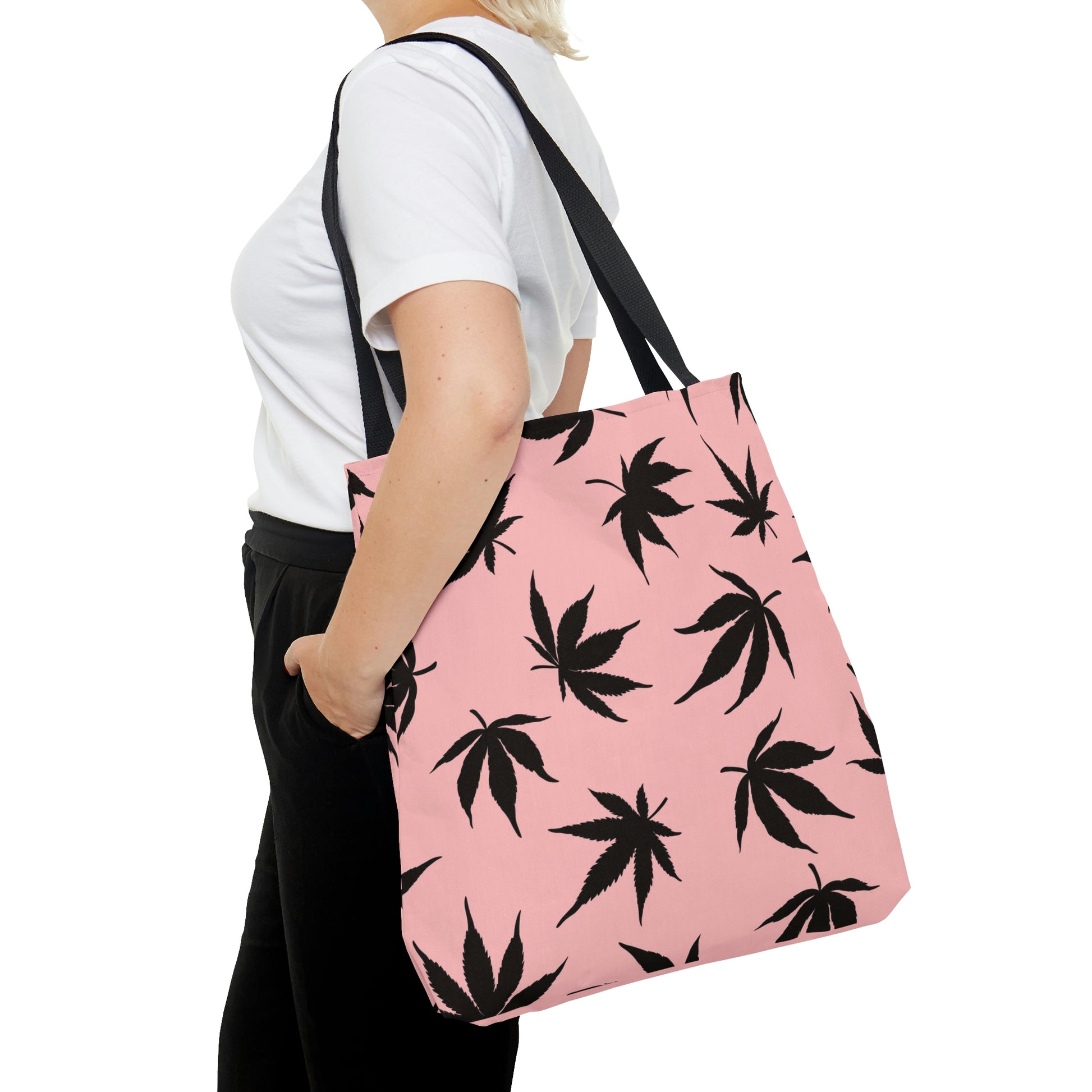 A woman is confidently wearing the Marijuana Leaves Pink Tote Bag